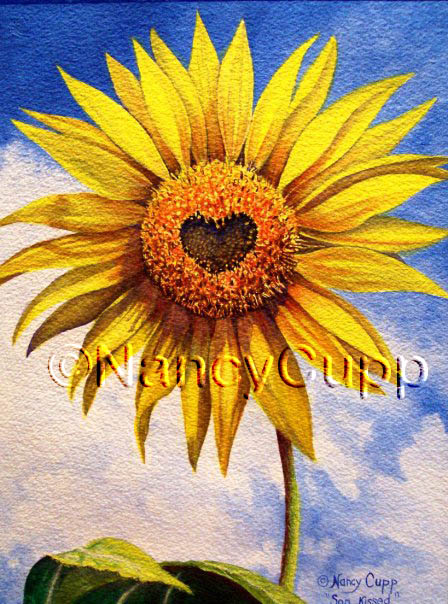 SON KISSED watercolor by Nancy Cupp of a yellow sunflower with a heart in the center, against a sky background