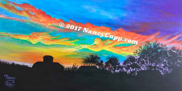 TRUMPET PRACTICE acrylic painting by Nancy Cupp of a brilliant purple and blue sky with orange and yellow clouds forming an angel blowing a trumpet. The silhouette of a barn and trees is in the foreground.